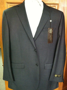 A suit that is on display in the closet.