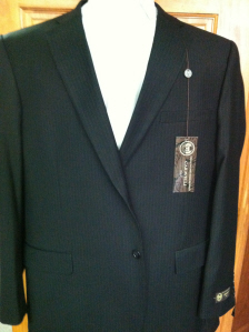 A suit jacket and tie with a tag on it.