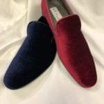 A pair of red and blue shoes on top of white cloth.