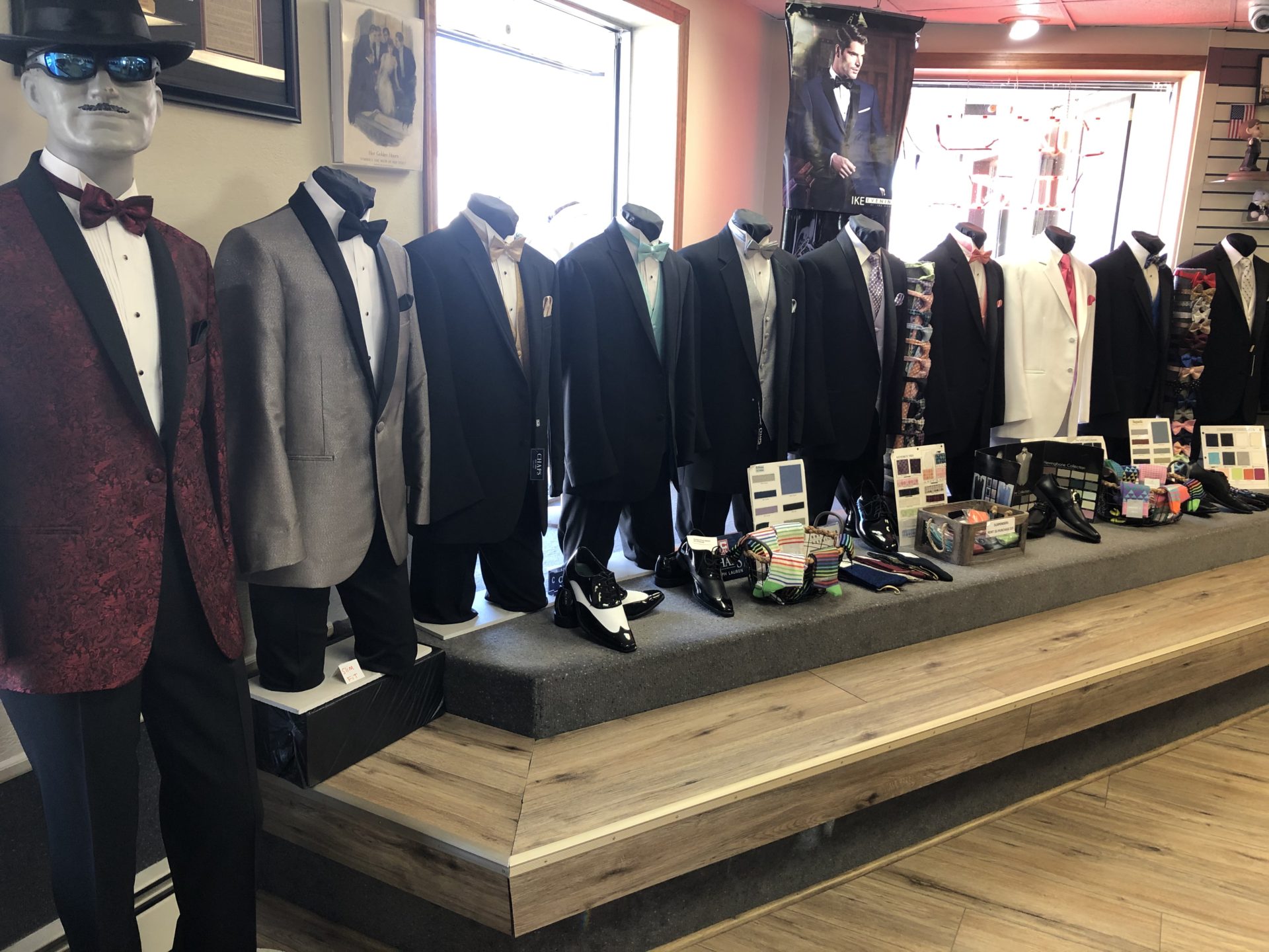 A room filled with suits and ties on display.
